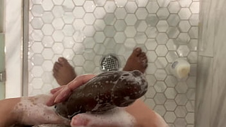 Stepsister joins stepbrother in shower and gives him a hand